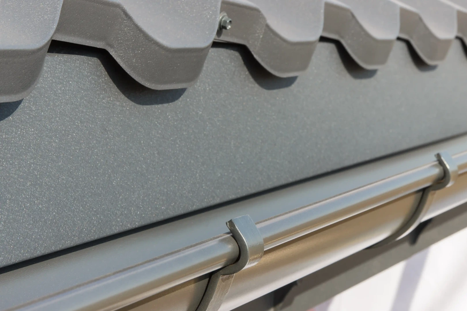 Clean gutter system installed along a residential roof edge